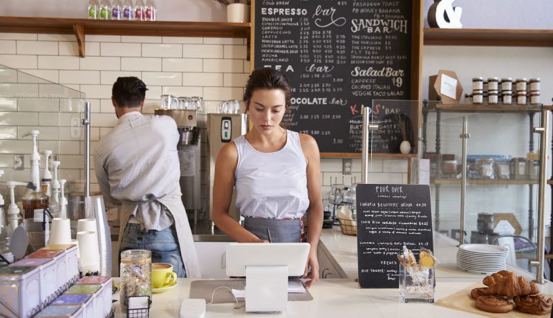 man and woman at work in a cafe