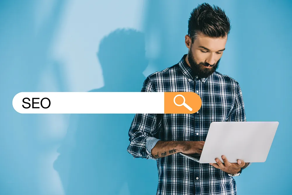 Business not showing up on Google, a man checking search results on his laptop next to an SEO search bar